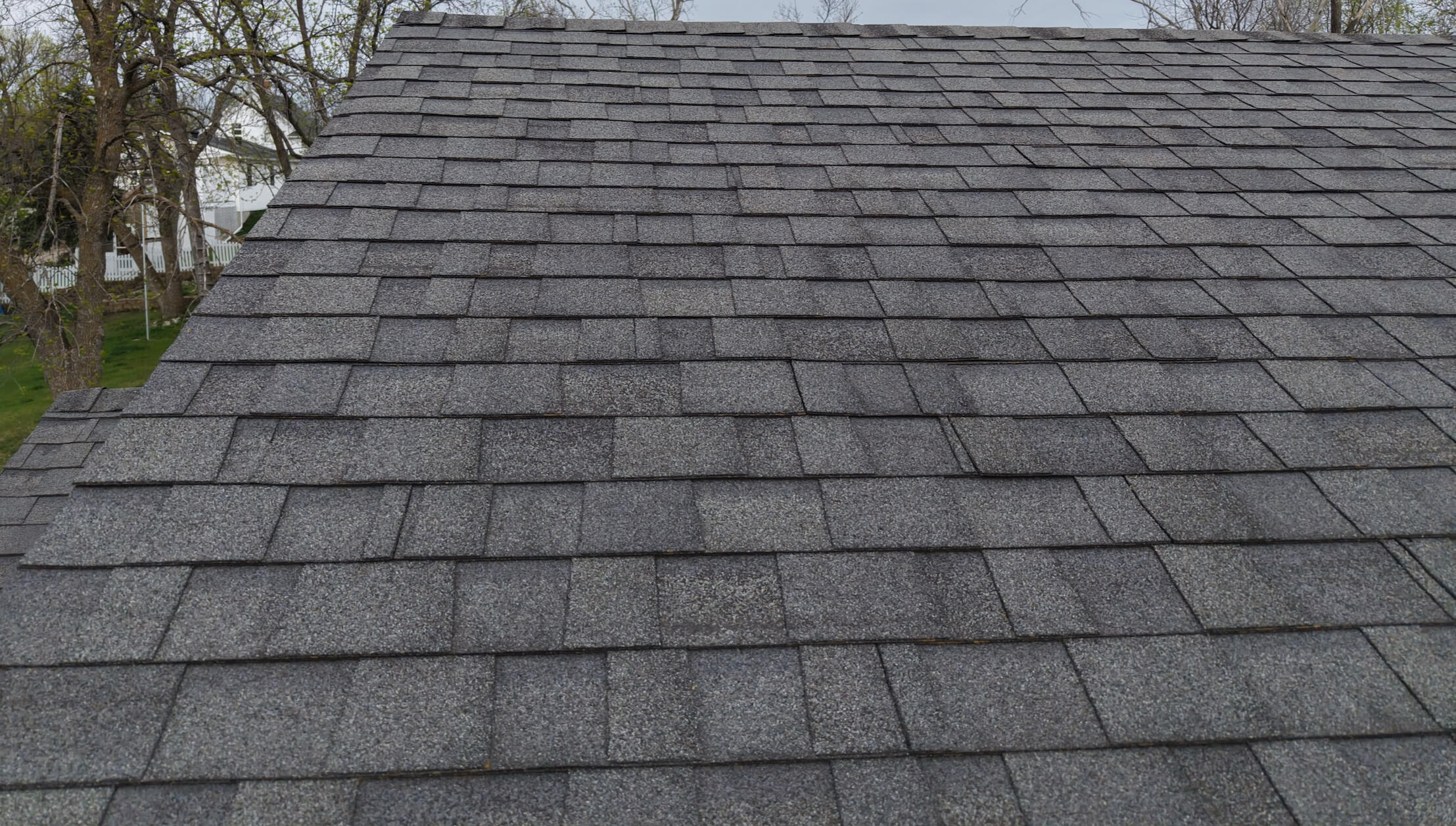 A picture of a shingled roof up close.